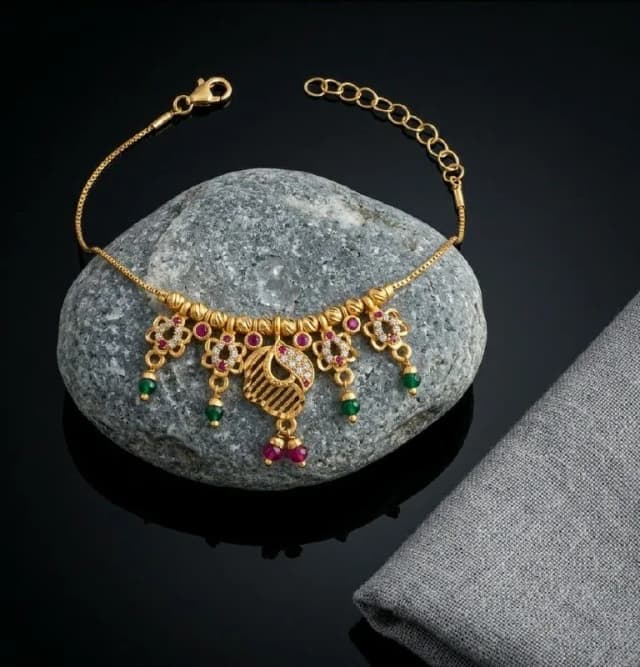 Gold Peacock Motif Ruby Charm Bracelet