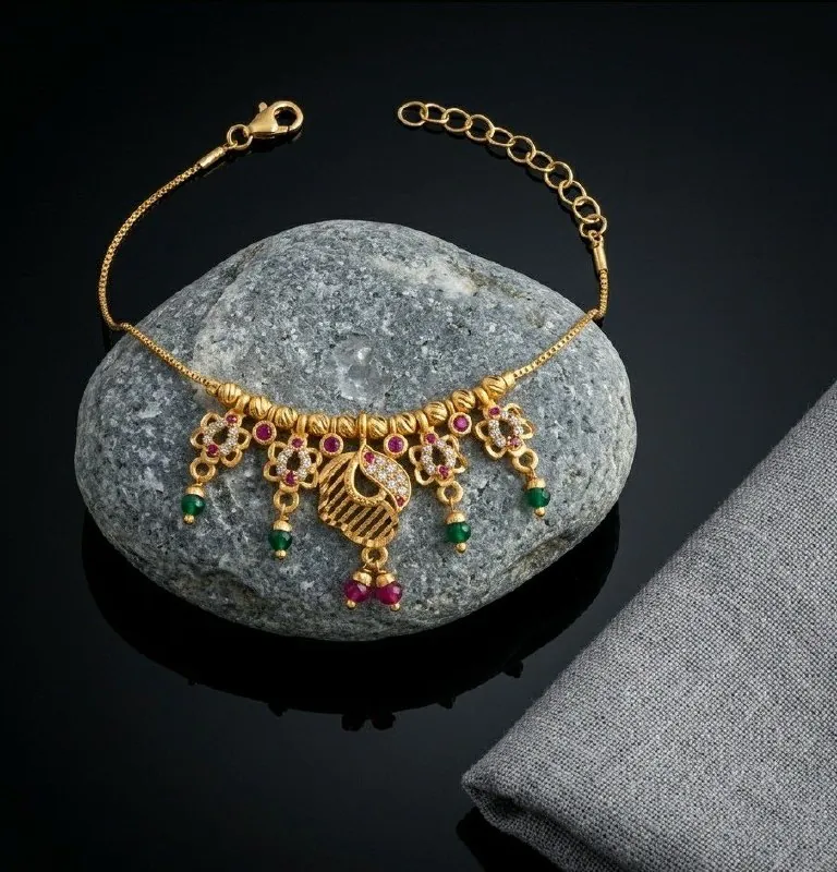 Gold Peacock Motif Ruby Charm Bracelet